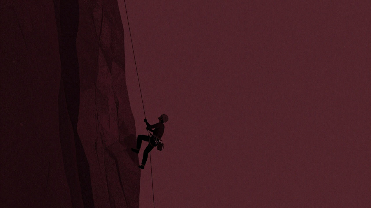 Side profile of a climber clinging to a steep rock face with only a rope, gazing up at the blue sky.