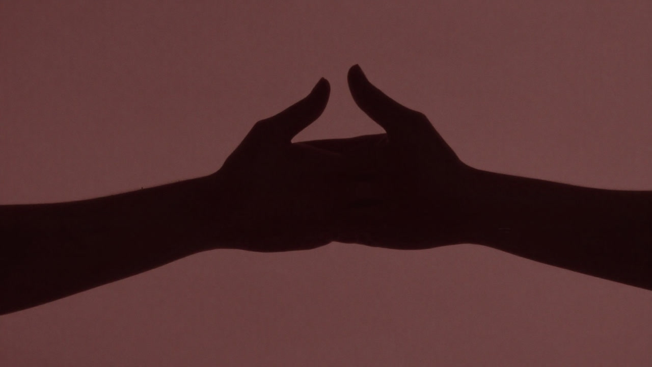Silhouette of two hands overlapped as if confirming mutual consent.