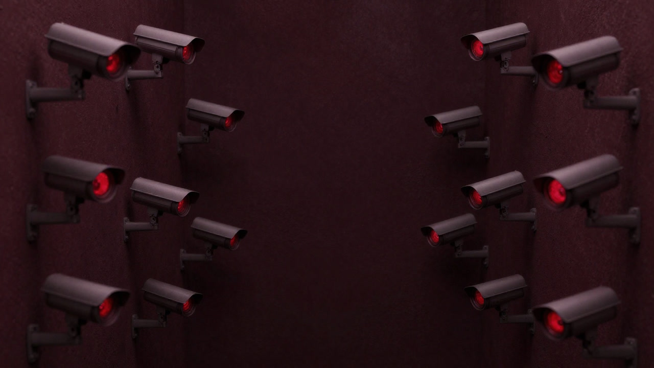 A city corner illuminated by countless surveillance camera lenses glowing red, eerily emerging from darkness.
