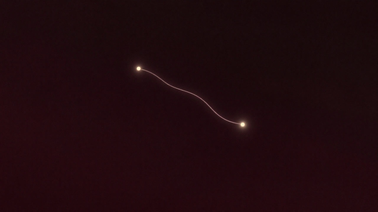 星空を背景に、光の糸で結ばれた二つの粒子が浮かぶイラスト