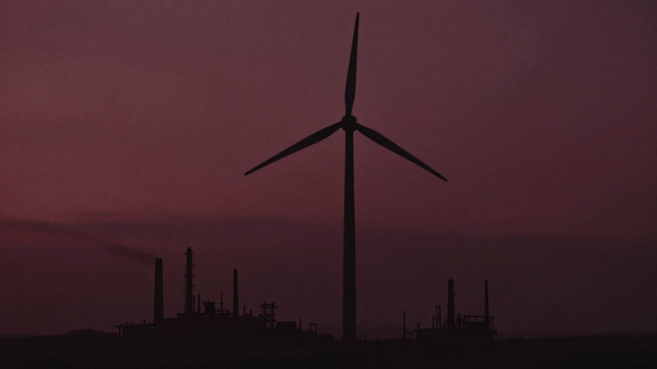 Silhouette of a wind turbine swaying uneasily in polluted air
