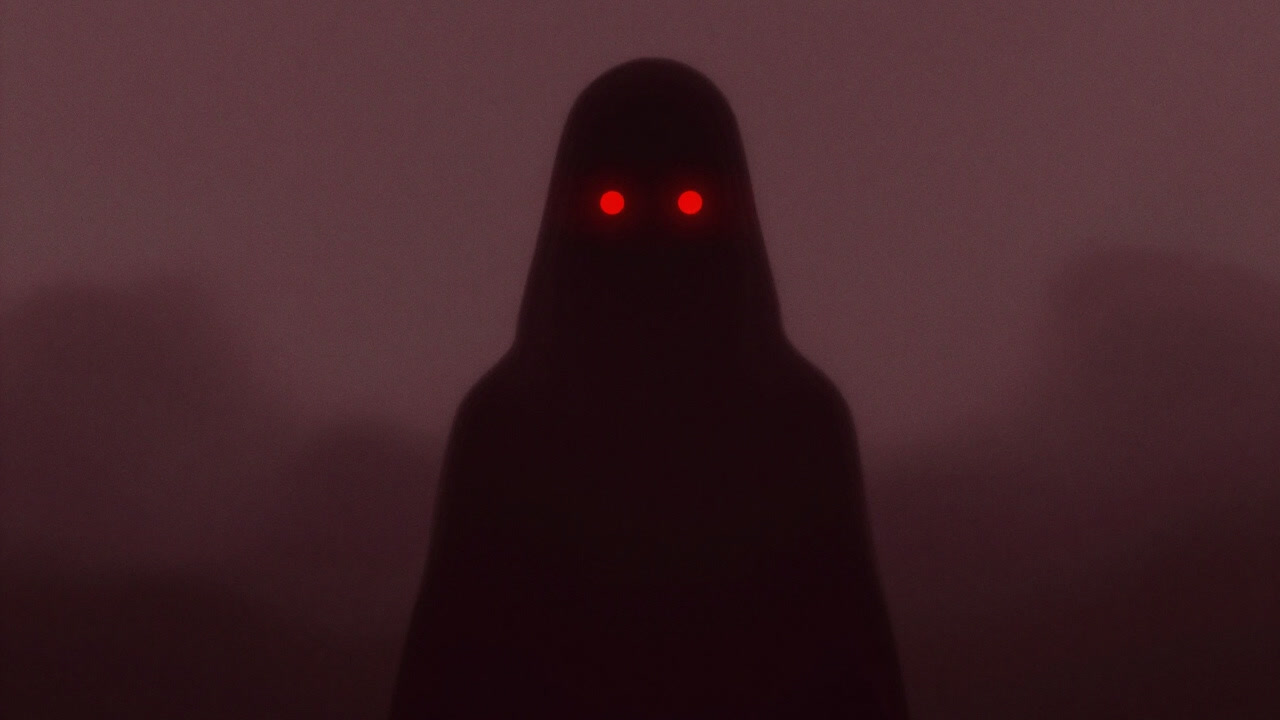 A silhouette figure with glowing red eyes emerging from darkness