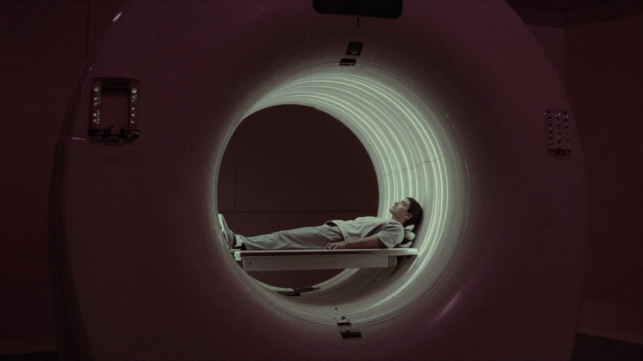 Subject lying in a cylindrical tube surrounded by glowing magnetic fields