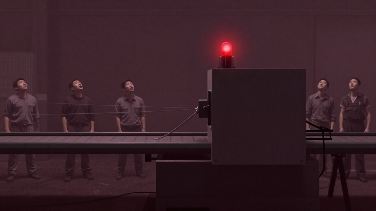 Photo of a machine on a production line stopped with a red alarm light, calling for a human.