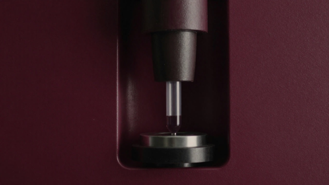 Sample tube being inserted into the inlet of a mass spectrometer