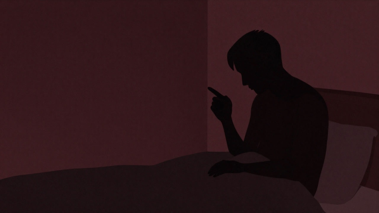 暗い部屋で一人、影の中で指先に集中する人物のシルエット