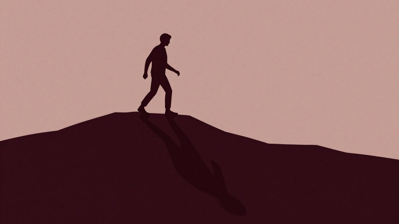 Silhouette of a person on a mountain peak struggling to transcend their own shadow
