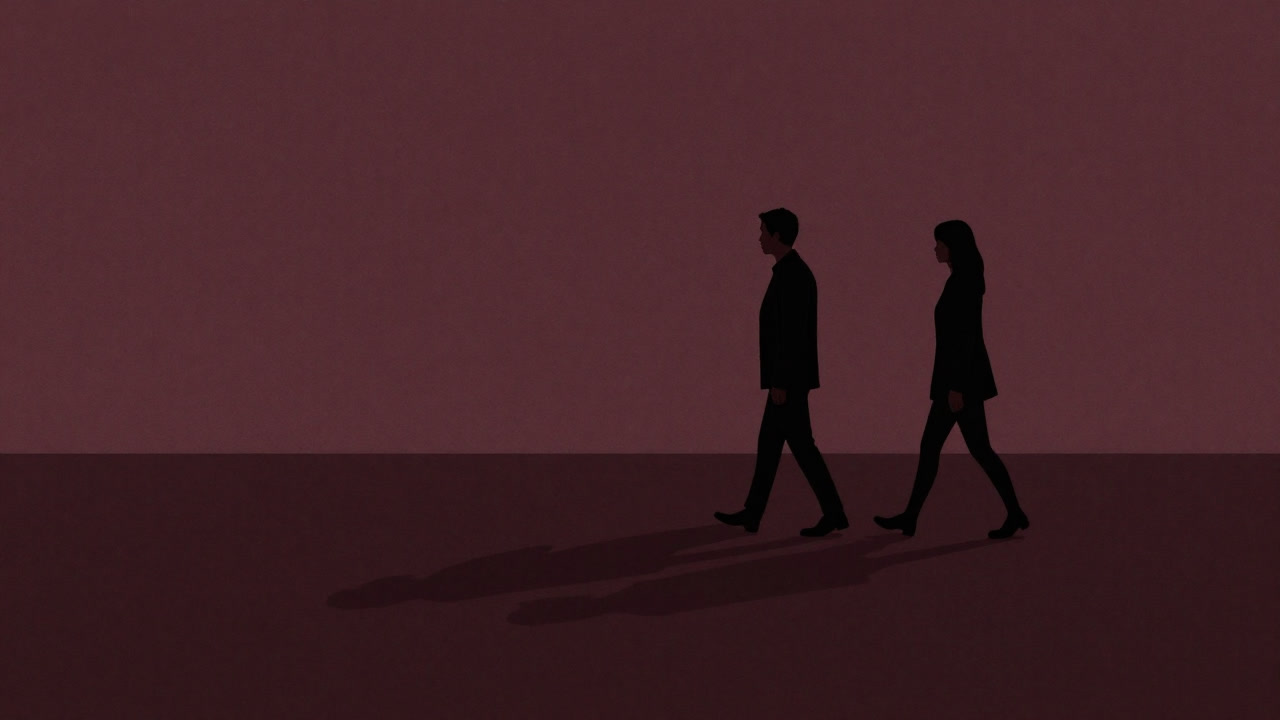 Silhouette of two people walking side by side in silence their long shadows stretching on the ground at dusk