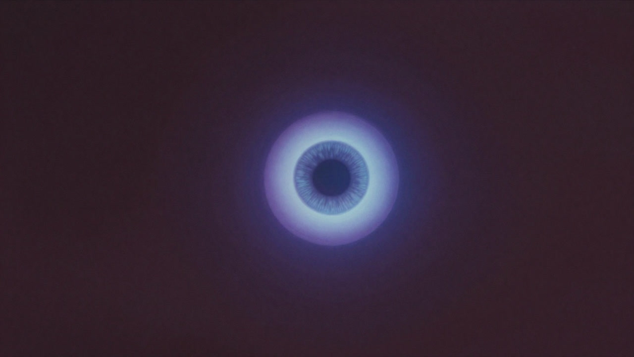 A glowing orb shaped like a third eye floating in a dimly lit space