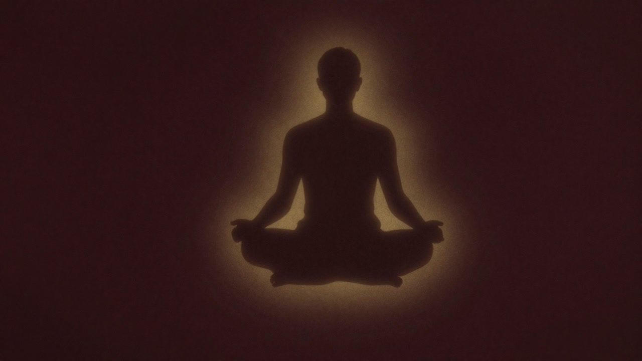 Silhouette of a person sitting cross-legged on a meditation mat, eyes closed and expressionless, gazing into space surrounded by floating golden light