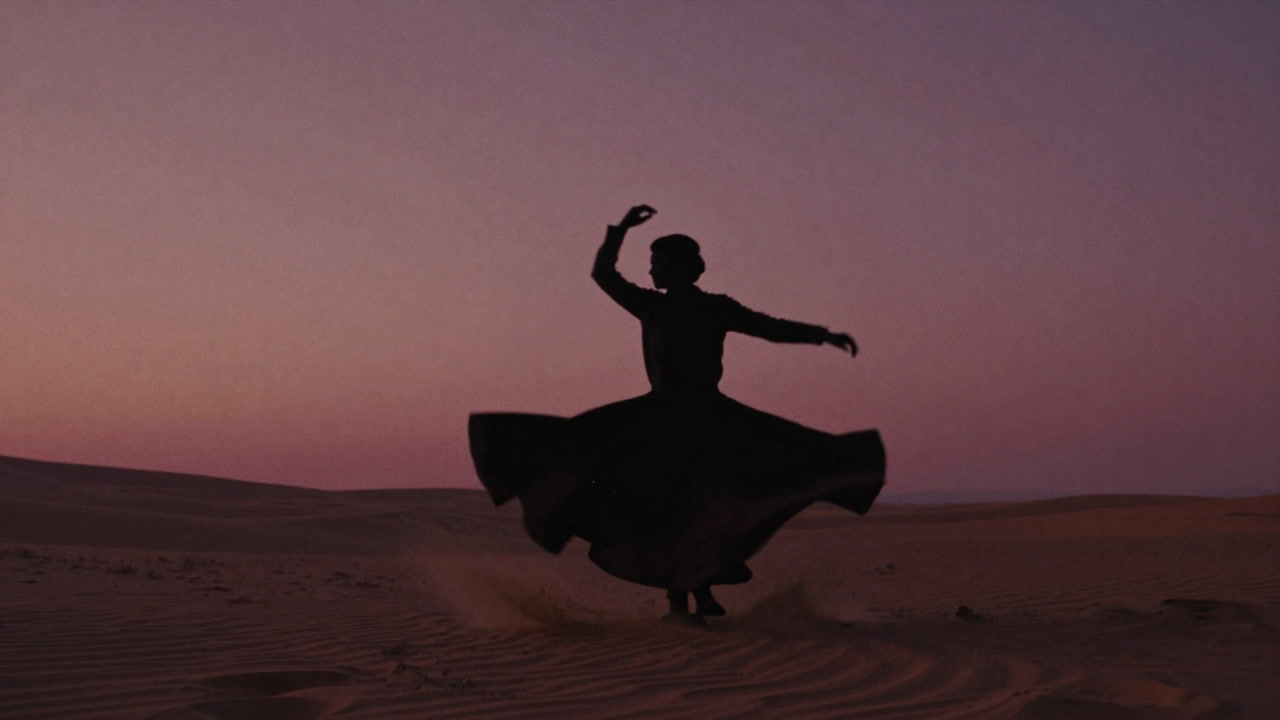 Silhouette of a practitioner spinning endlessly in a desert